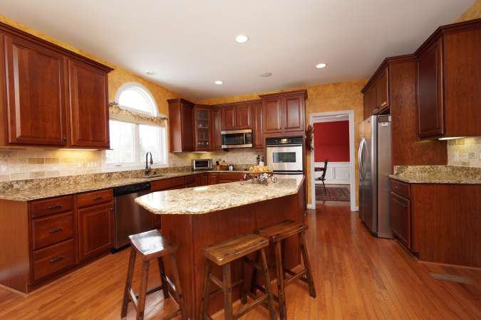 Warm Wood Cherry Cabinetry and Hardwood Flooring